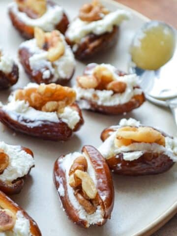 A plate of dates stuffed with goat cheese and walnuts.
