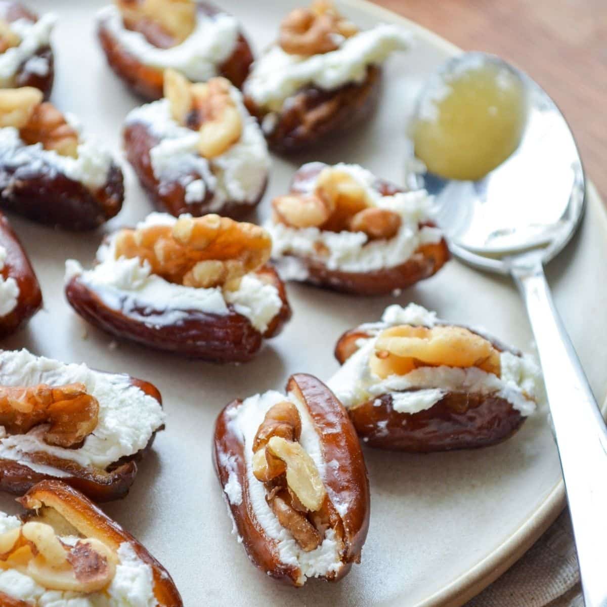 A plate of dates stuffed with goat cheese and walnuts.