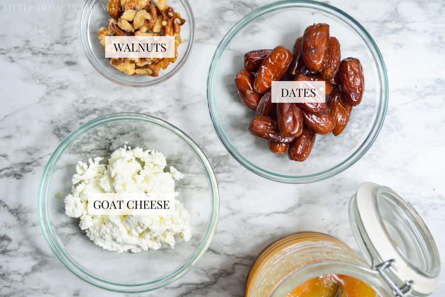 dates, walnuts, and goat cheese on a marble counter