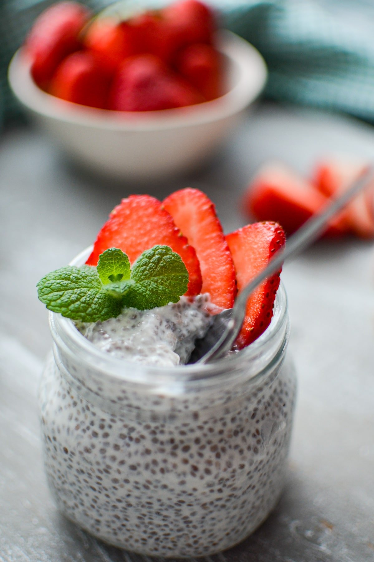 A spoon in a jar of chia pudding