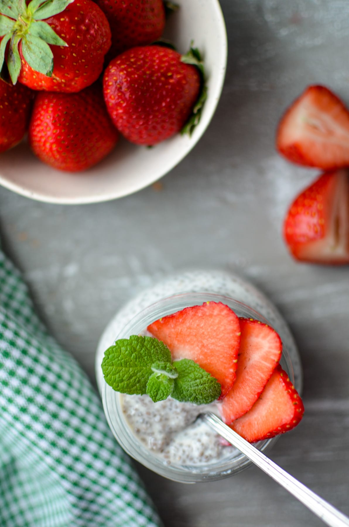 An overhead view of strawberries, and a snack size jar