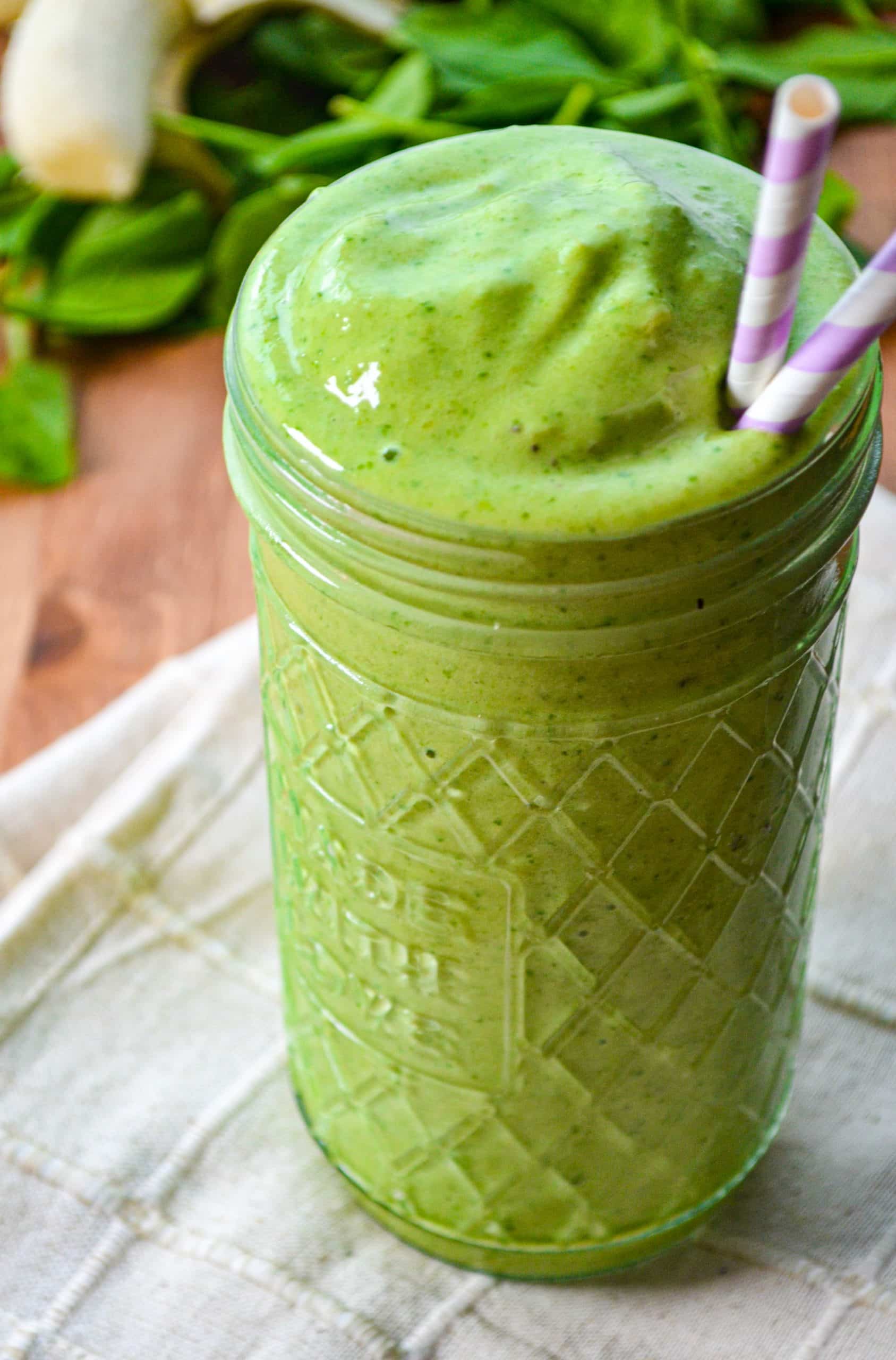 A glass jar filled with a kefir green smoothie.