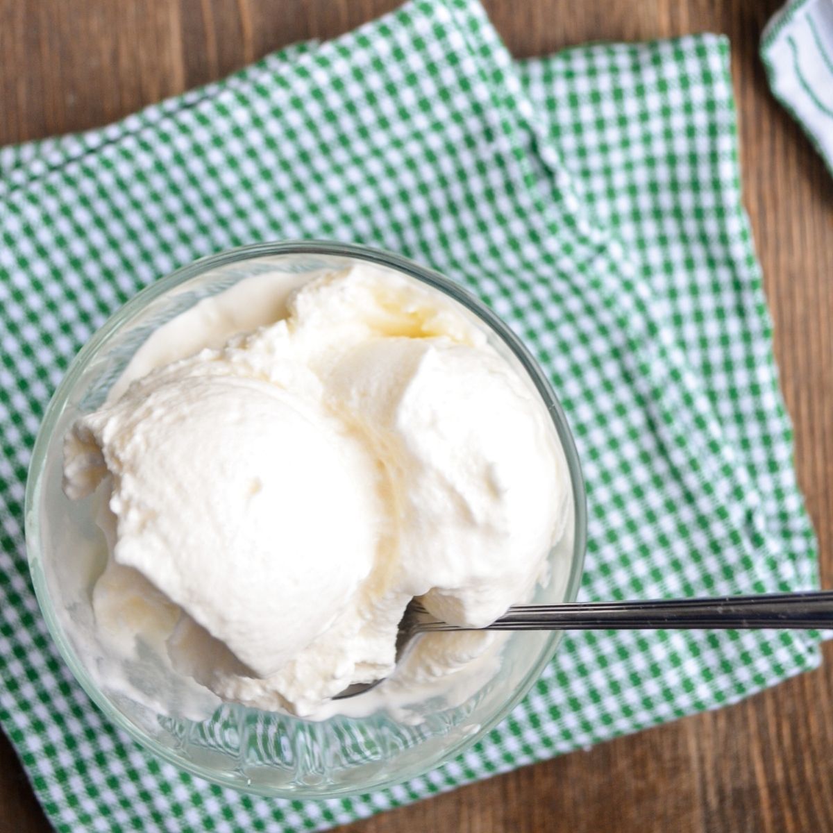 A bowl of snow ice cream on a green check napkin.