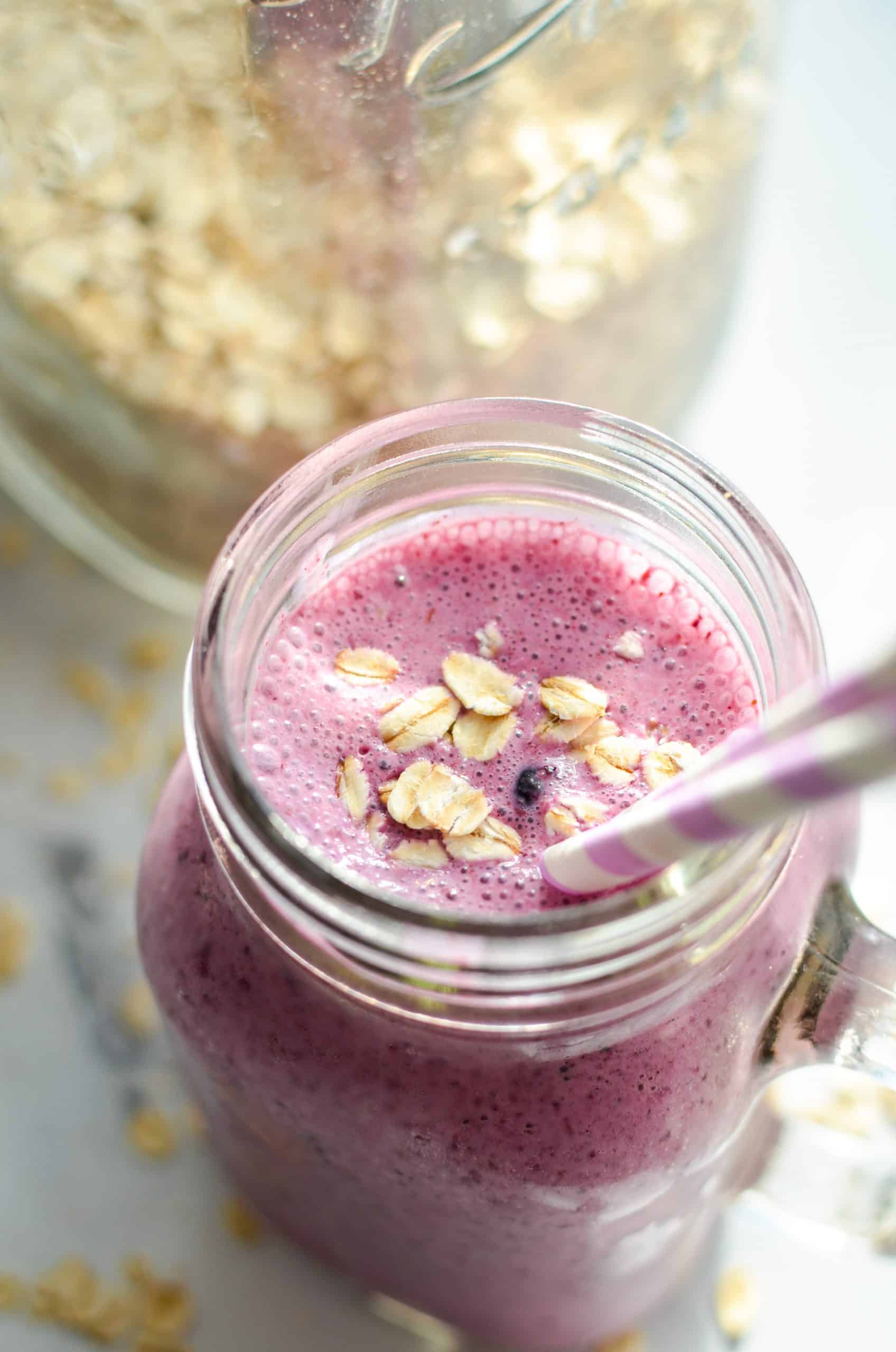 A blueberry smoothie garnished with oatmeal