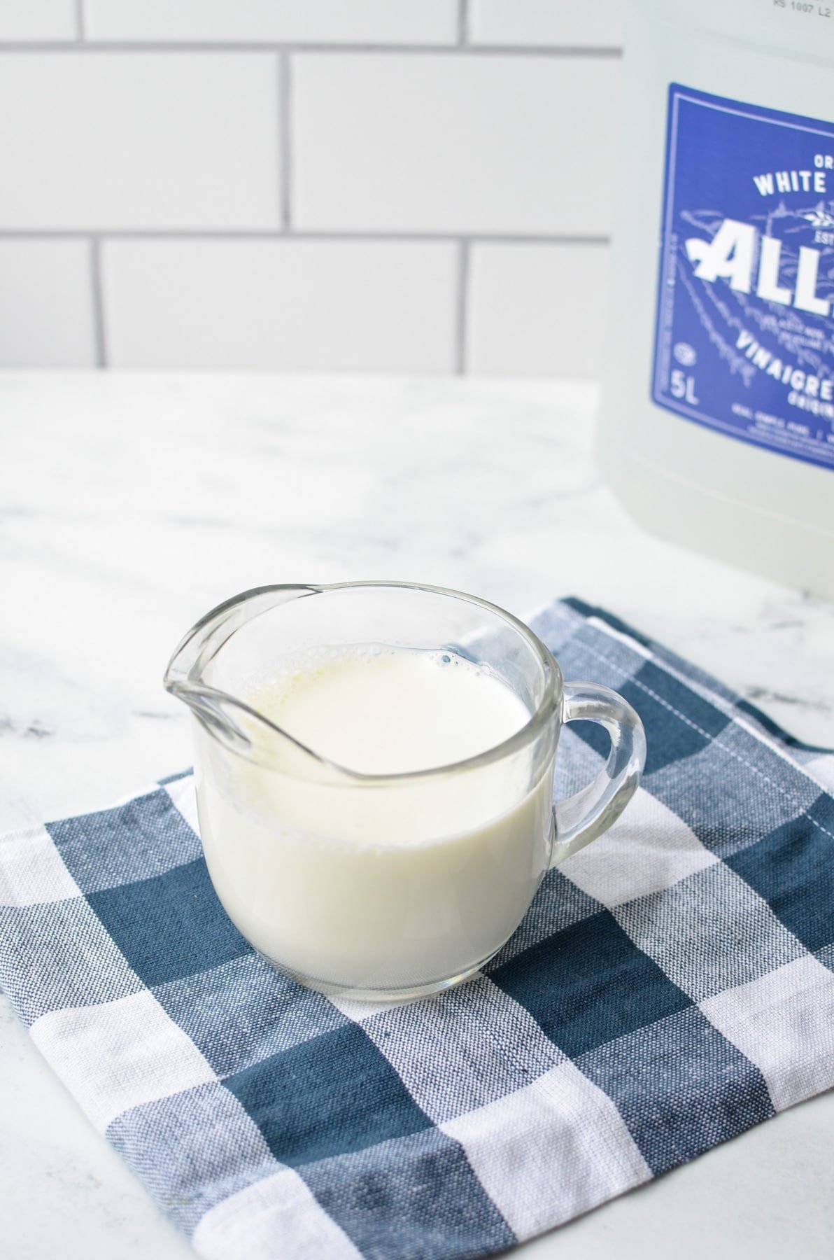 The ingredients needed to make a buttermilk substitute: vinegar and milk.