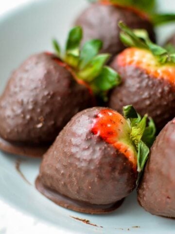 a plate of coconut oil chocolate covered strawberries