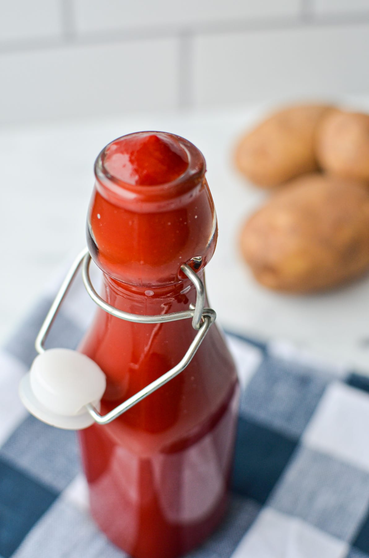 A close up of a bottle of homemade ketchup