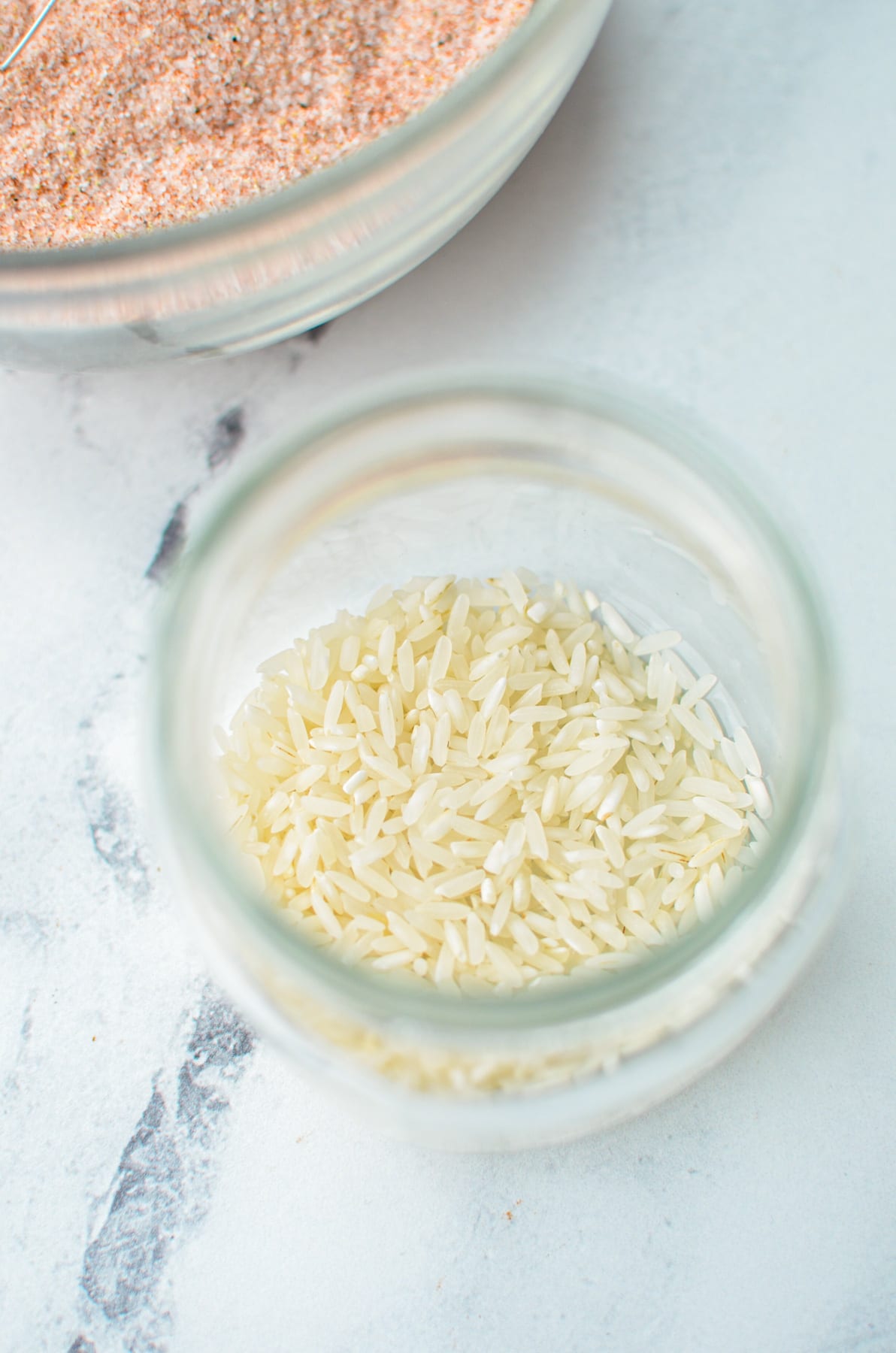 A jar of rice to prevent clumping in homemade seasoning blends.