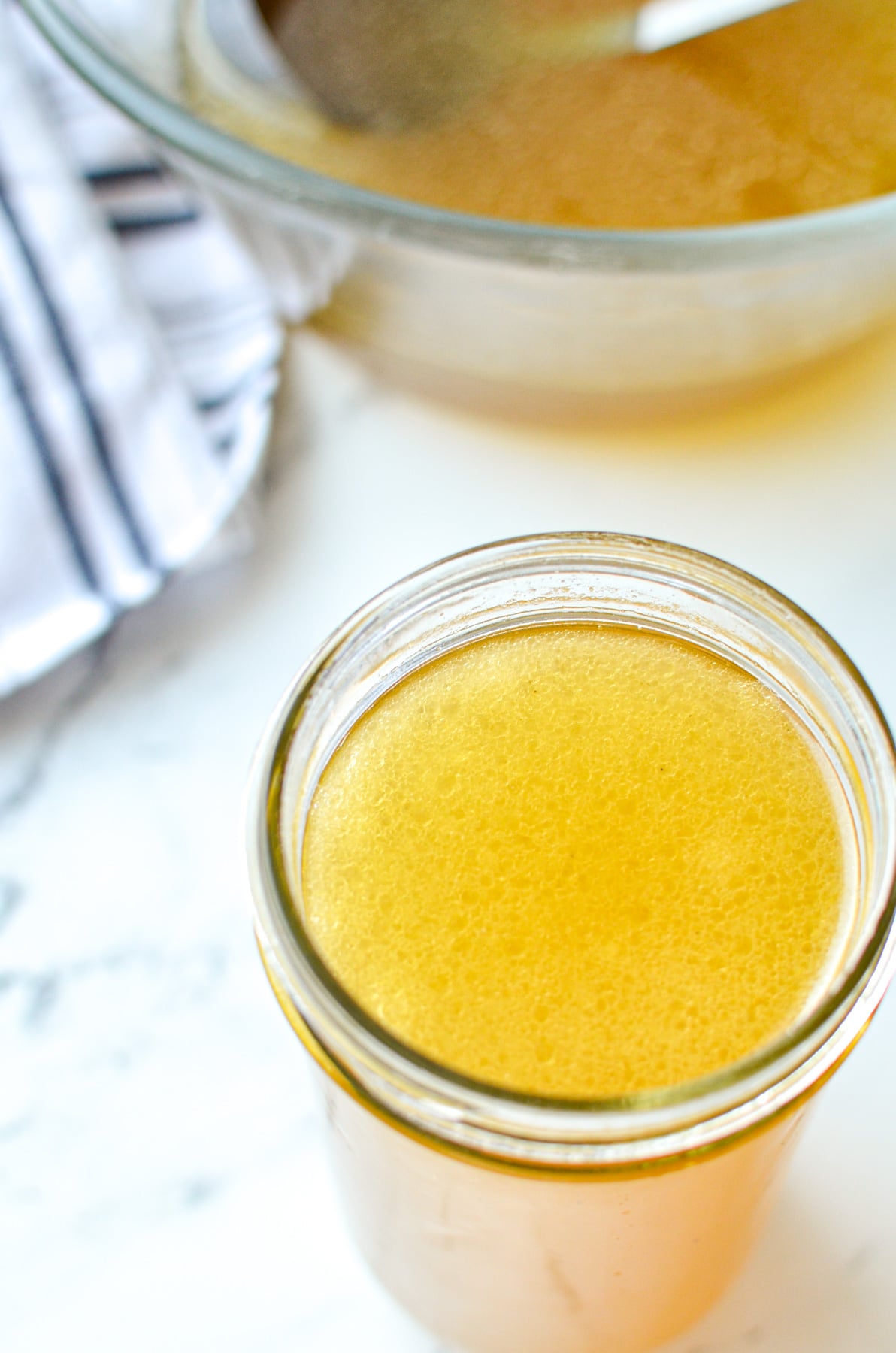 A jar full of homemade chicken broth