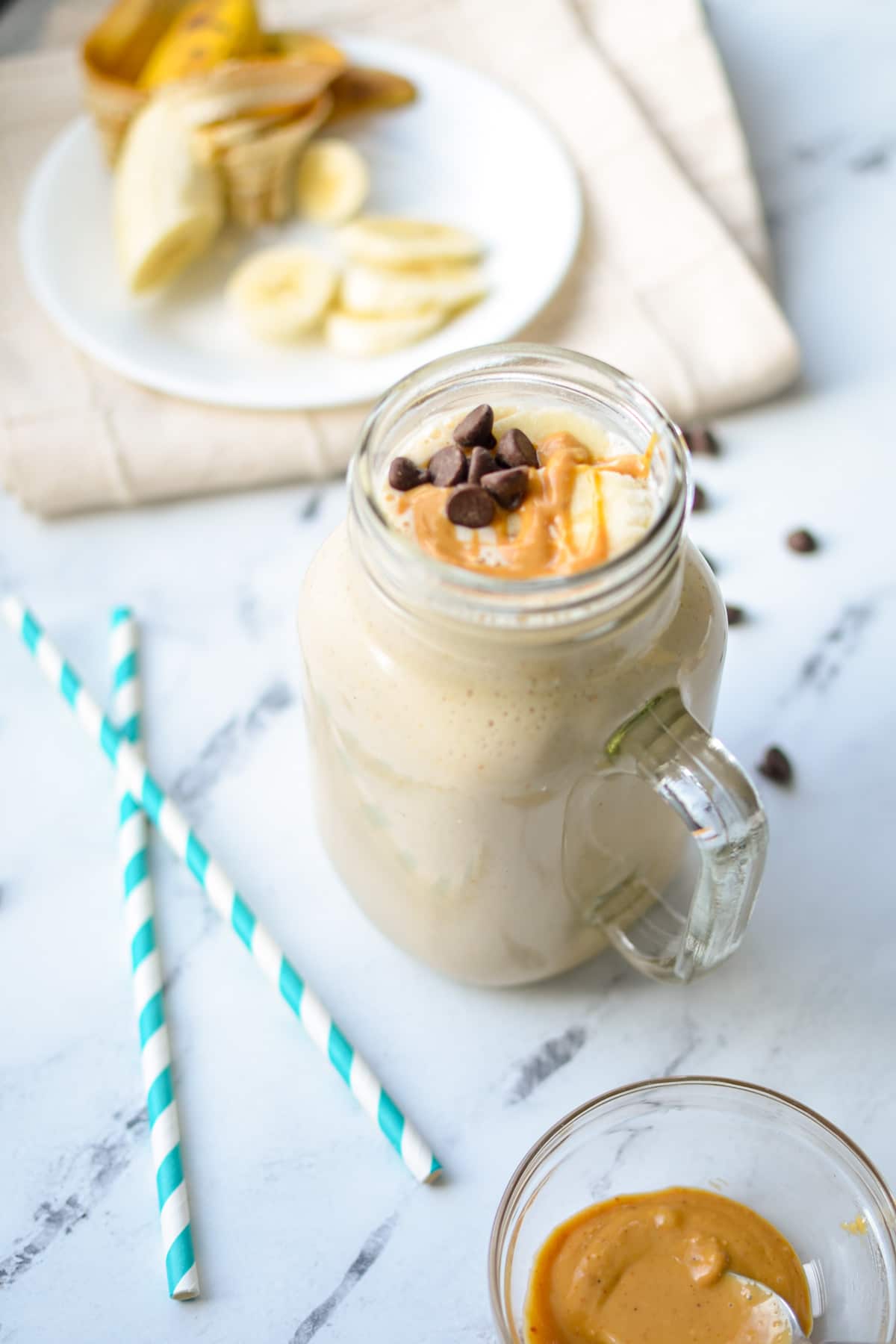 A glass filled with a peanut butter and banana kefir protein smoothie.