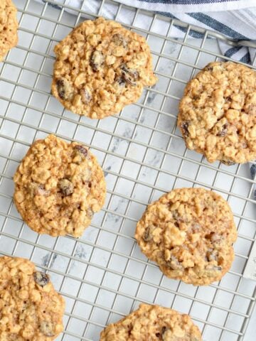 A cooling rack with sourdough oatmeal cookies on it.