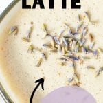 A glass mug filled with a tea latte, and sprinkled with dried lavender buds. The text overlay reads: london fog latte. Copycat recipe.