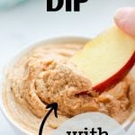 A small bowl of peanut butter dip with an apple being dipped into it. The text overlay reads: peanut butter dip with greek yogurt.