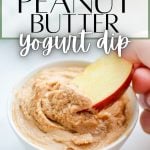 A small bowl of yogurt dip with an apple dipping into it. The text overlay reads: peanut butter yogurt dip.