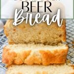 A loaf of sourdough beer bread, sliced on a cooling rack. The text overlay reads: sourdough beer bread.