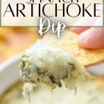 A chip dipping into a hot dip. The text overlay says: spinach artichoke dip.
