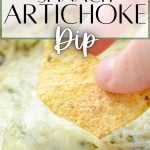 A chip dipping into a hot dip. The text overlay reads: spinach artichoke dip.