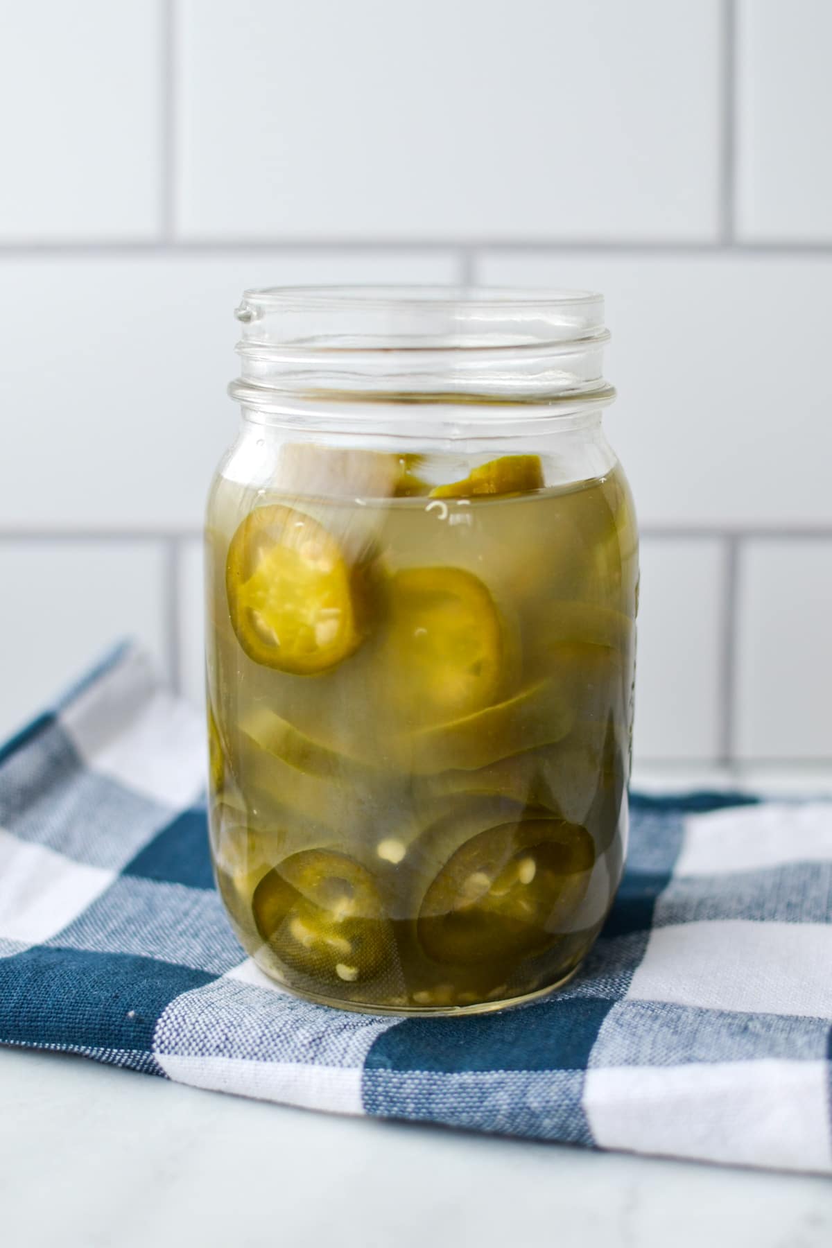 A jar of fully fermented jalapenos.
