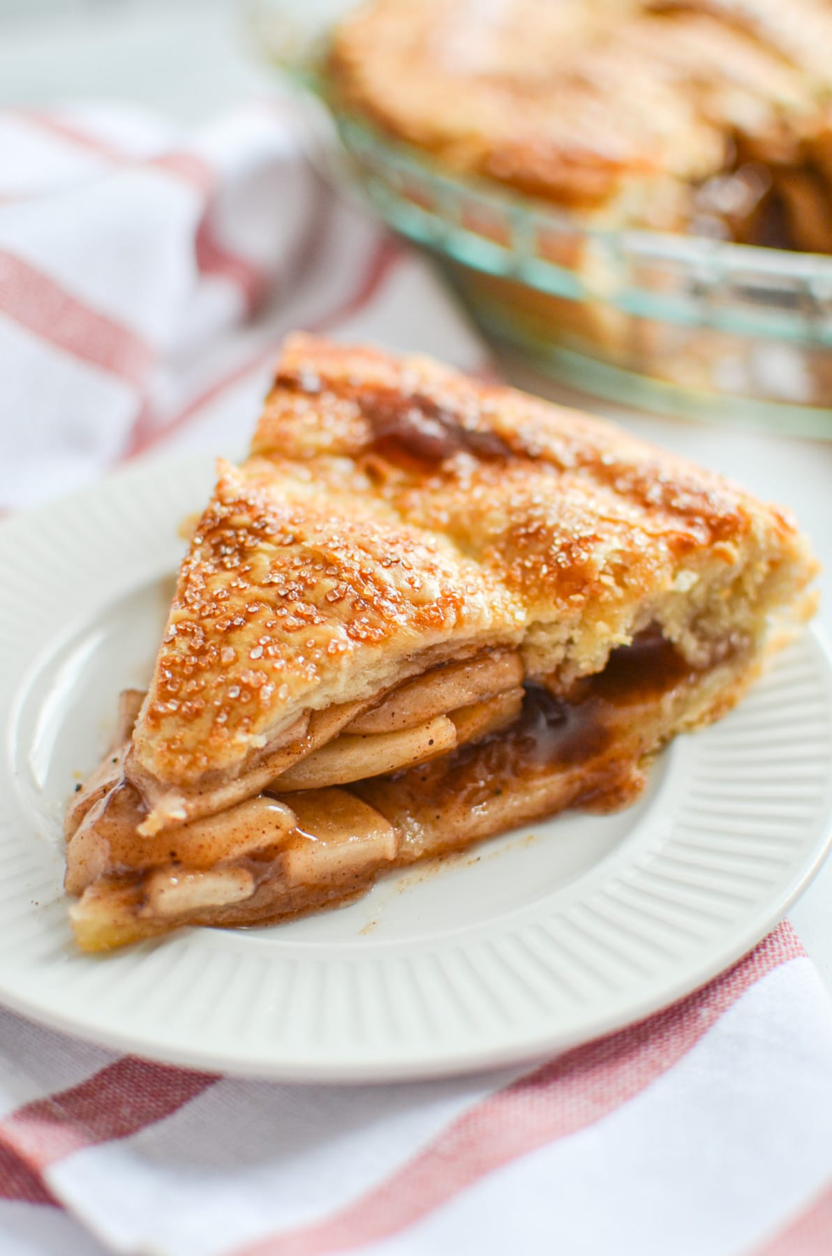 A slice of sourdough apple pie on a white plate.