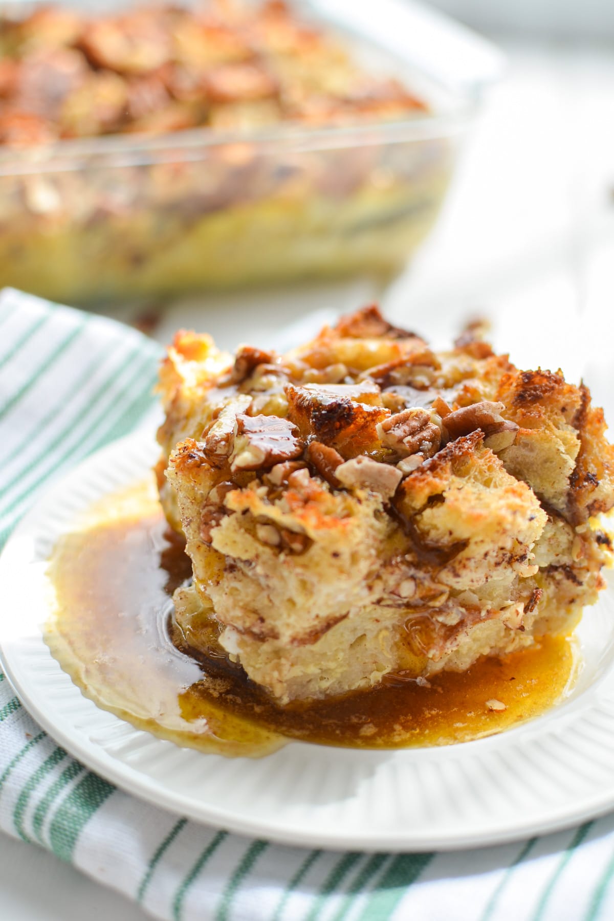 A square of bread pudding, drizzled in sauce.