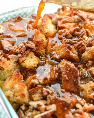 A close up of a pan of sourdough bread pudding, being topped with a brown sugar topping.