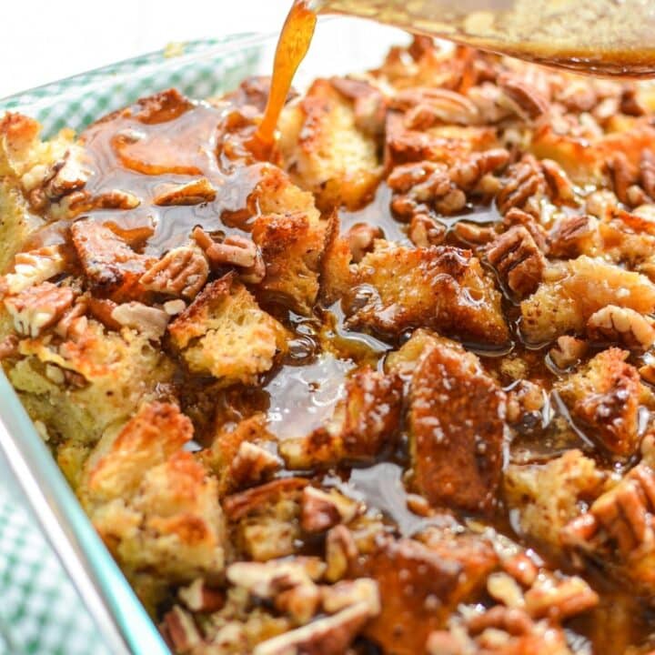 A close up of a pan of sourdough bread pudding, being topped with a brown sugar topping.