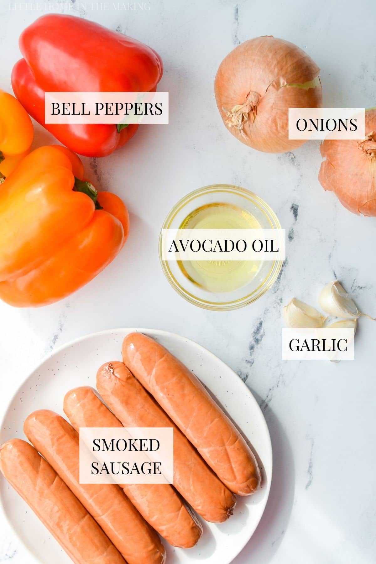 The ingredients needed to make sausage and peppers. Includes smoked sausage, bell peppers, and onions.