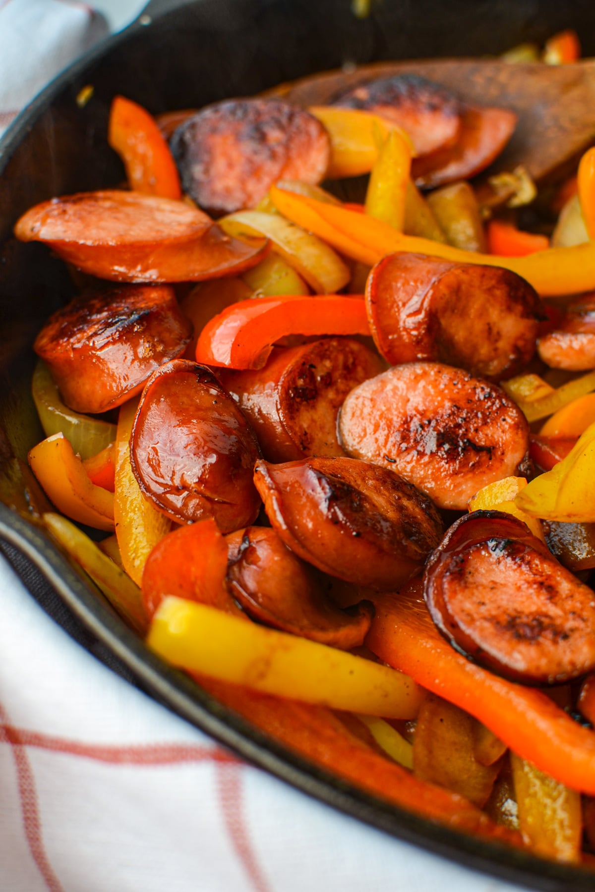 A skillet of sausage slices and peppers.