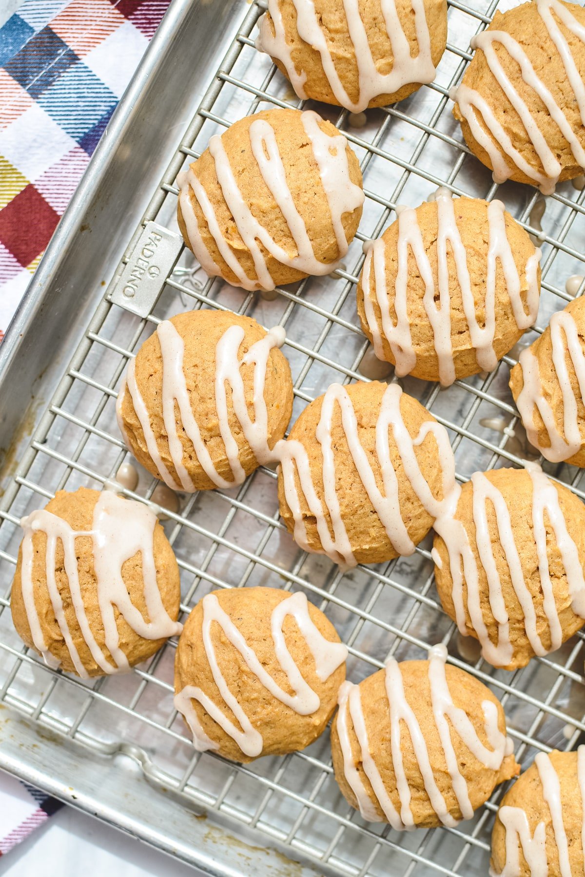 Pumpkin cookies on a baking sheet.