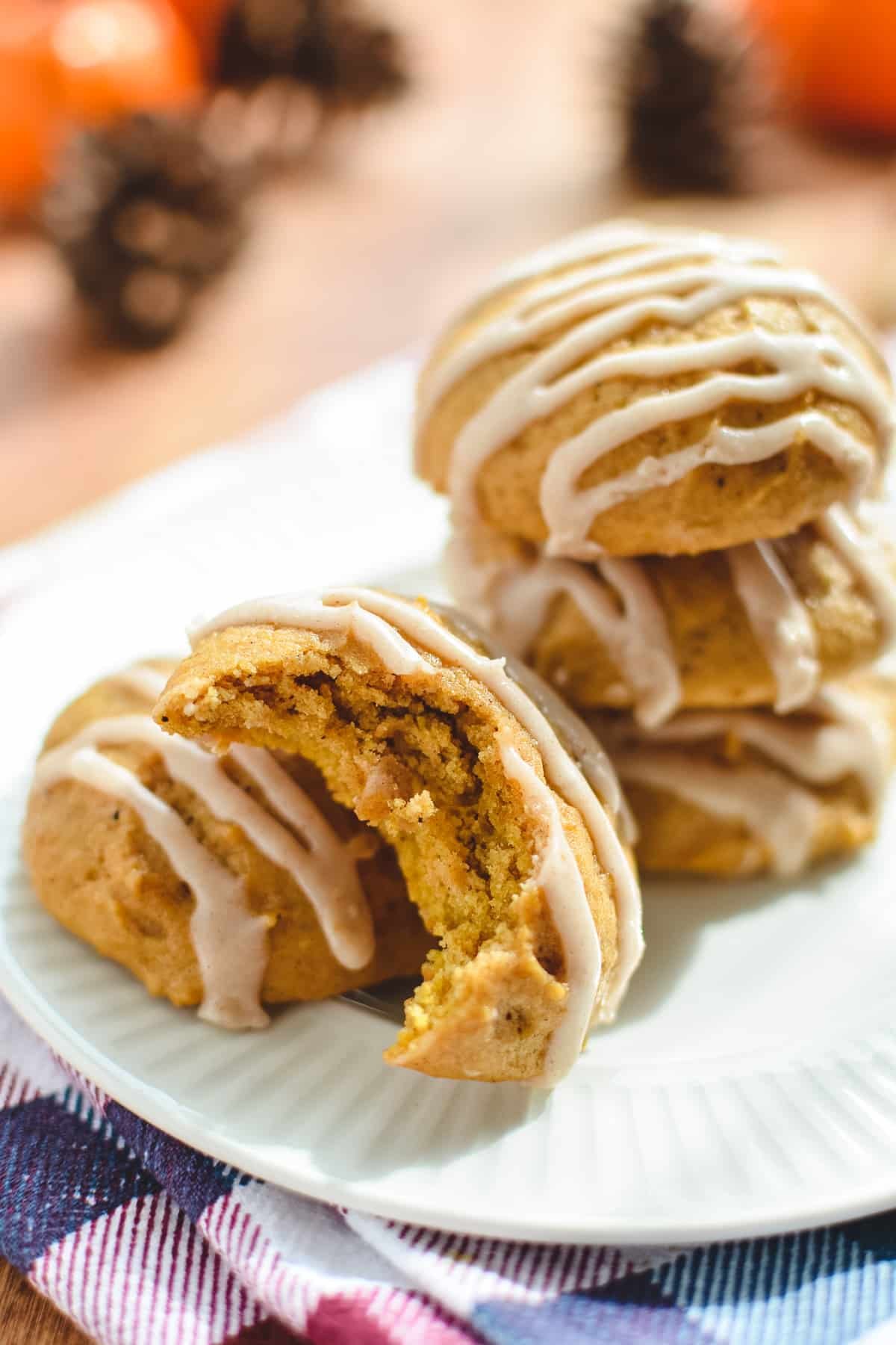 Stacks of pumpkin cookies with a bite taken out of one.
