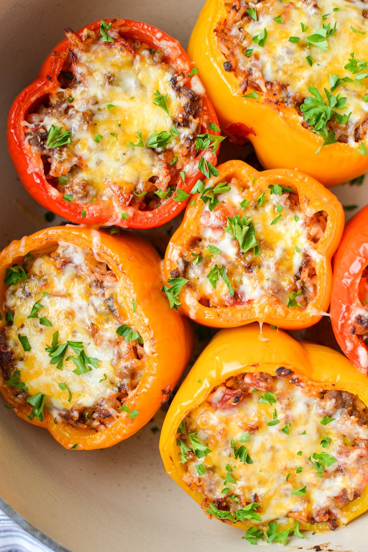 A close up of a dutch oven with stuffed peppers inside.