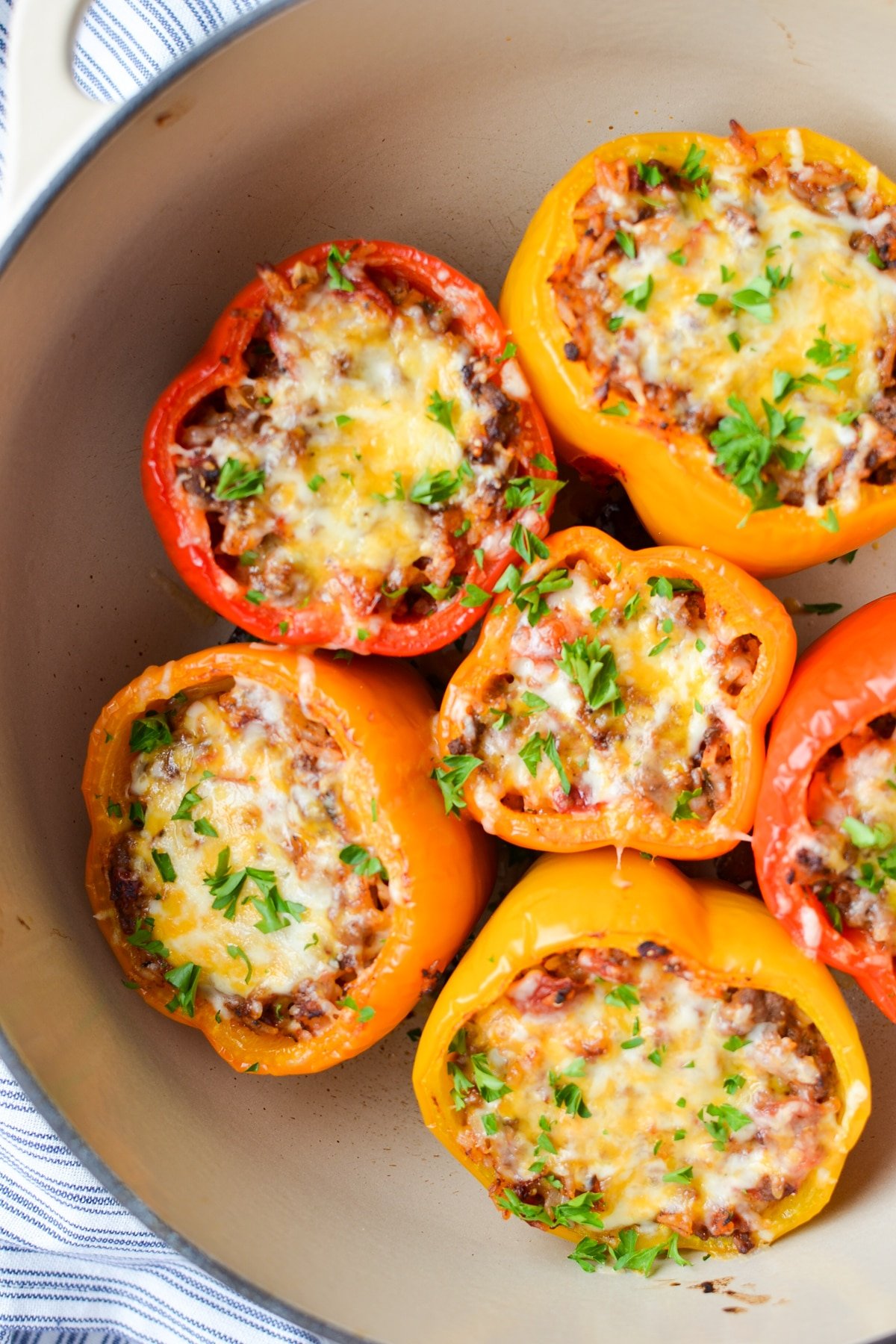 A dutch oven filled with colorful stuffed peppers.
