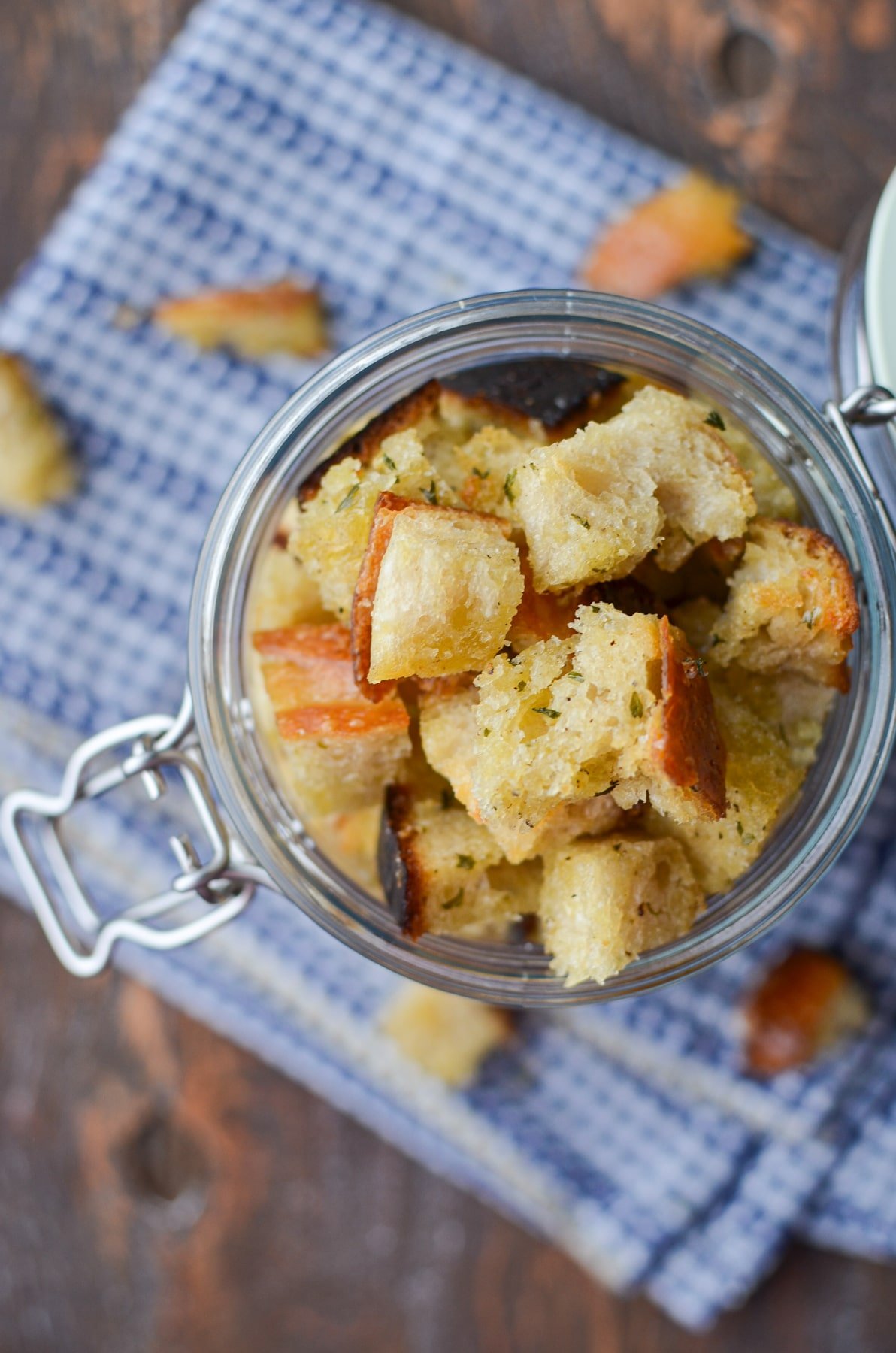 An overhead view of a jar of sourdough croutons.