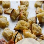 A sheet pan with sourdough croutons on it.