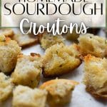 A close up of sourdough croutons on a sheet pan.