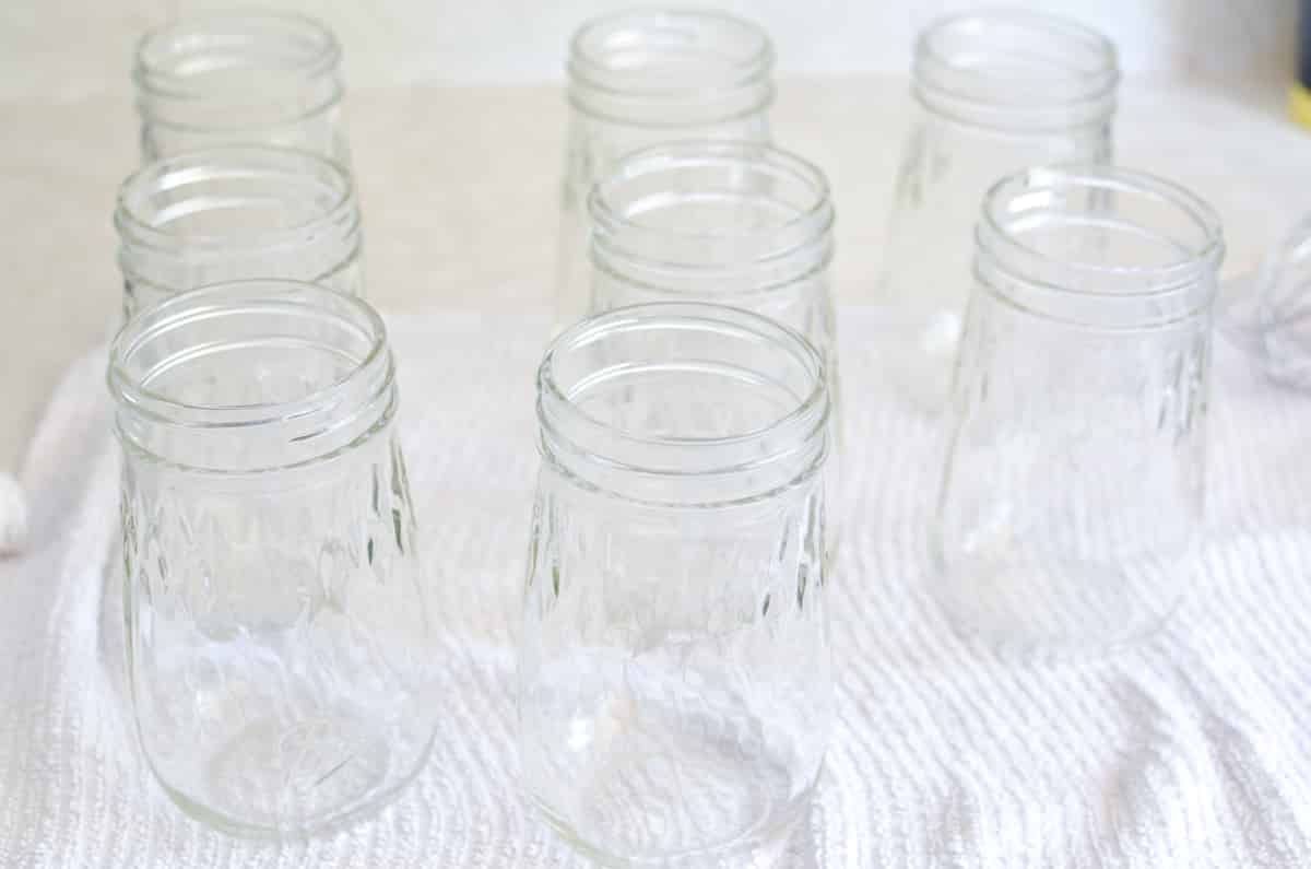 A towel with clean, sterilized canning jars on it.