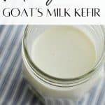 A jar of kefir on a blue striped kitchen towel.