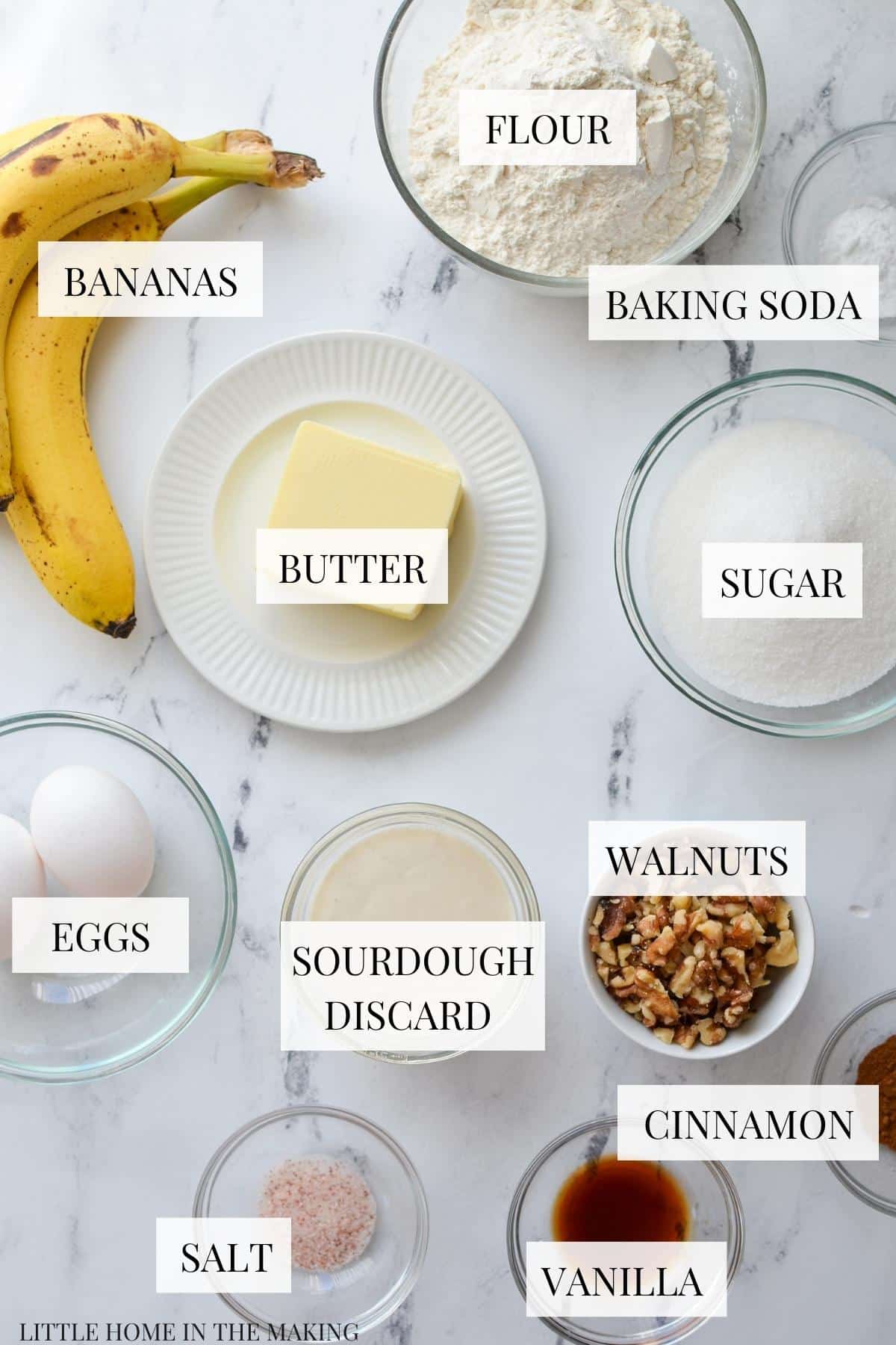 The ingredients needed to make sourdough banana bread, including ripe bananas, sugar, flour, and sourdough discard.
