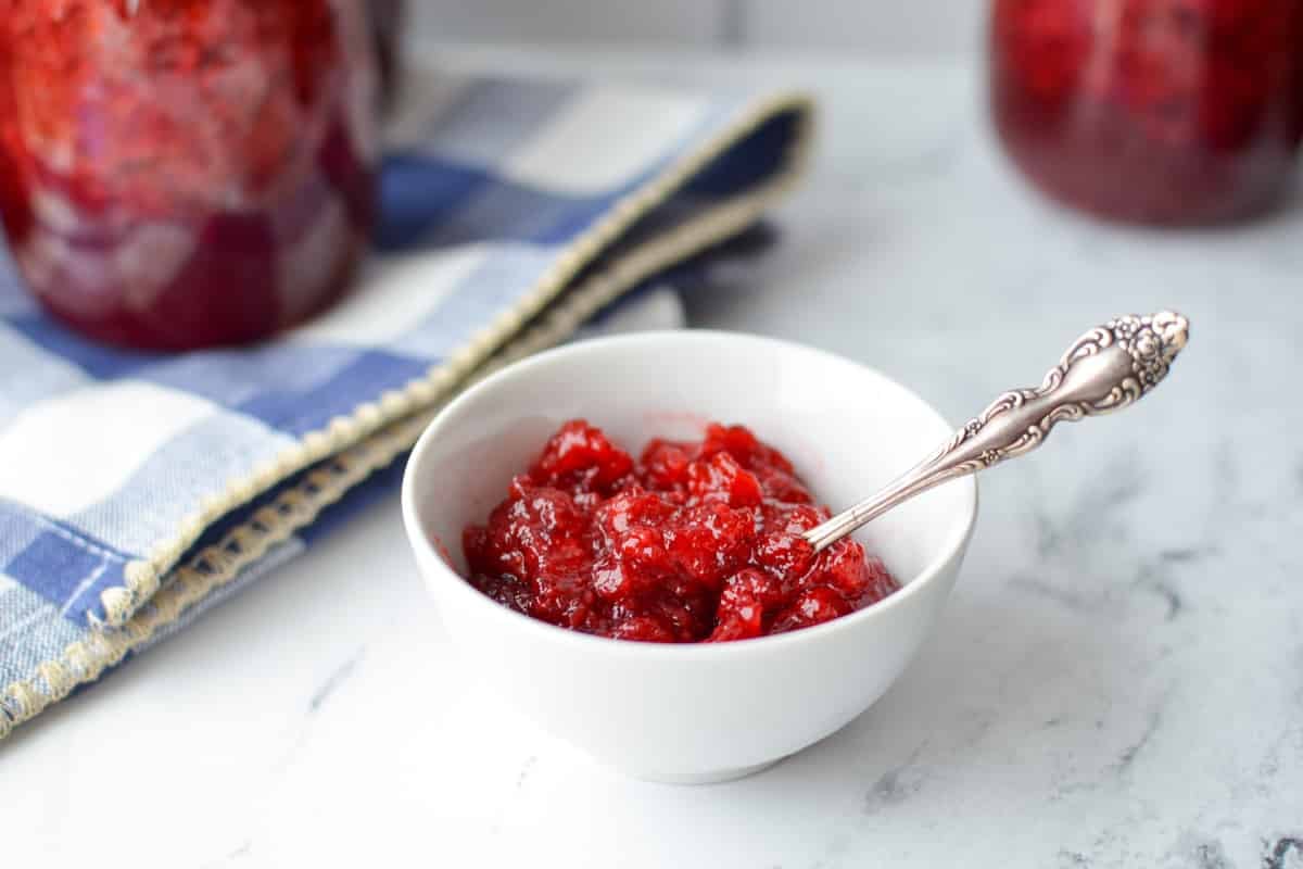 A small white bowl of homemade strawberry jam.
