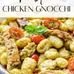 A bowl of gnocchi with pesto, chicken and cherry tomatoes.