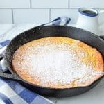 A cast iron skillet with a baked Dutch baby (German pancake) inside.
