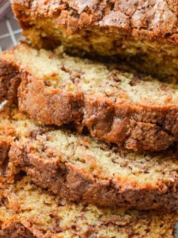 A close up of slices of a quick bread swirled with cinnamon.