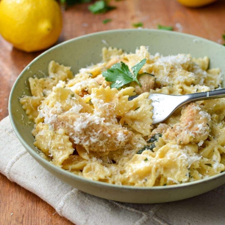 A bowl of bowtie pasta with a creamy lemon sauce.