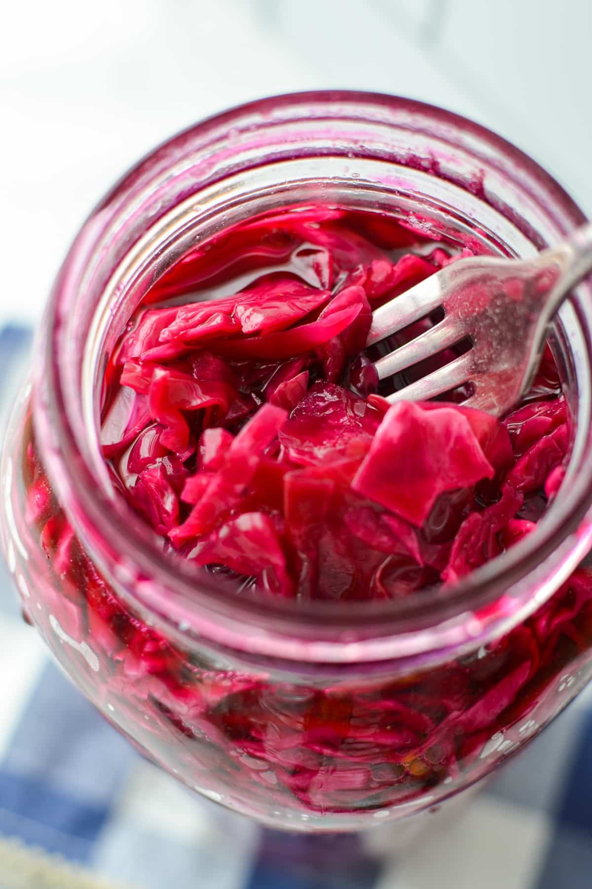 A jar of shredded cabbage that is red/purple in color.