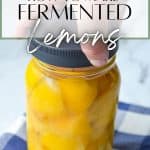 A jar of lemons that are covered in juice.