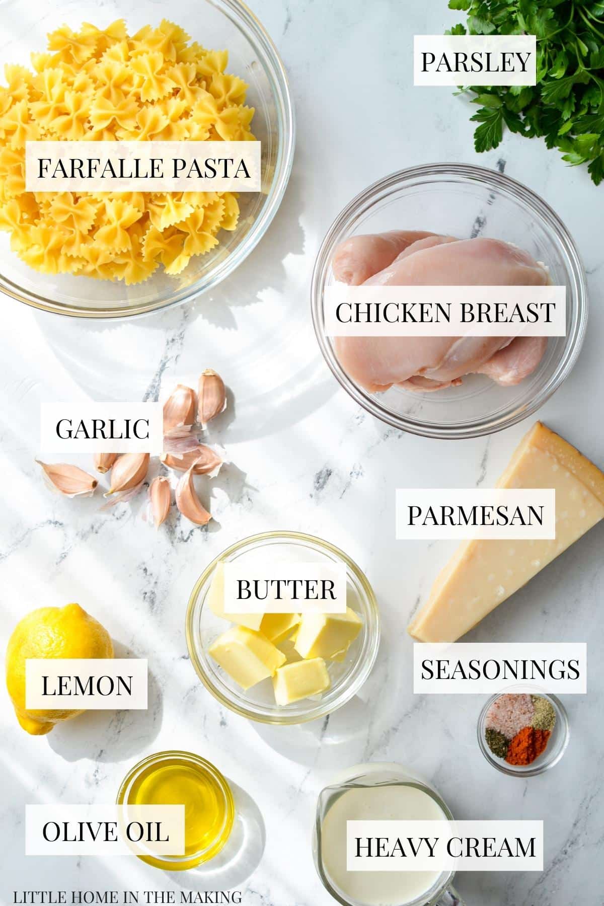 The ingredients needed to make lemon pasta: parmesan, chicken, butter, heavy cream, garlic, etc.