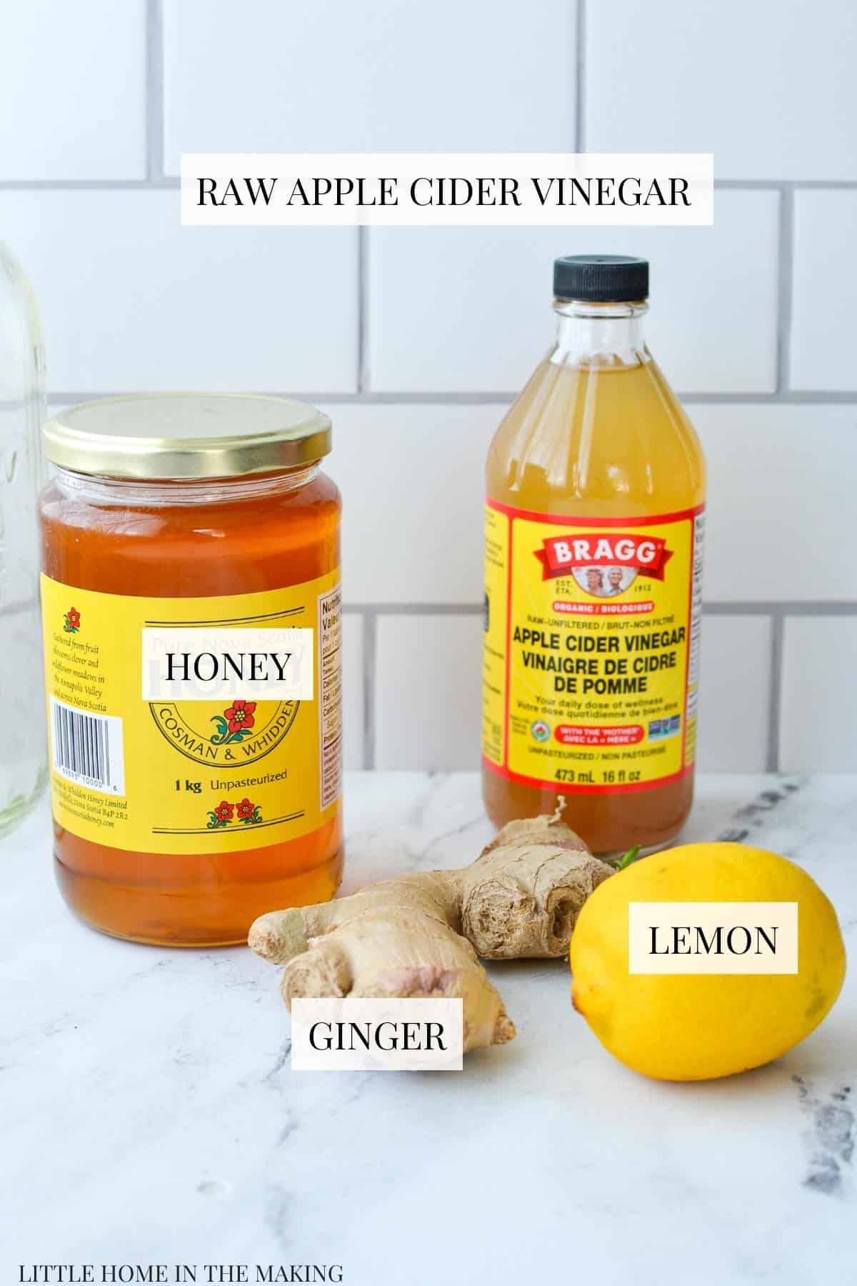 The ingredients needed to make haymakers punch: honey, lemon, ACV, and ginger.