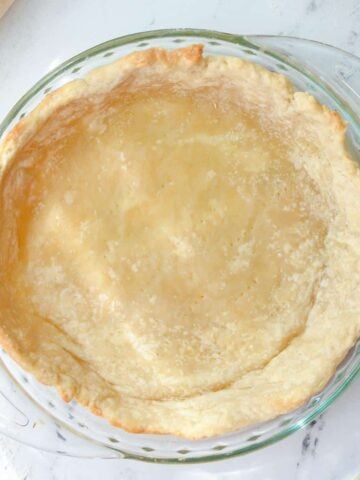 A partially baked homemade pie crust.
