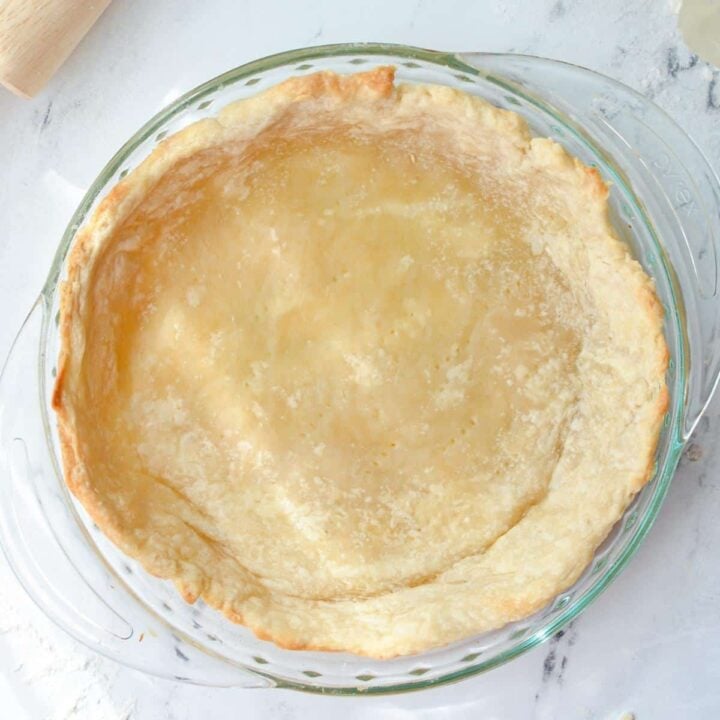 A partially baked homemade pie crust.