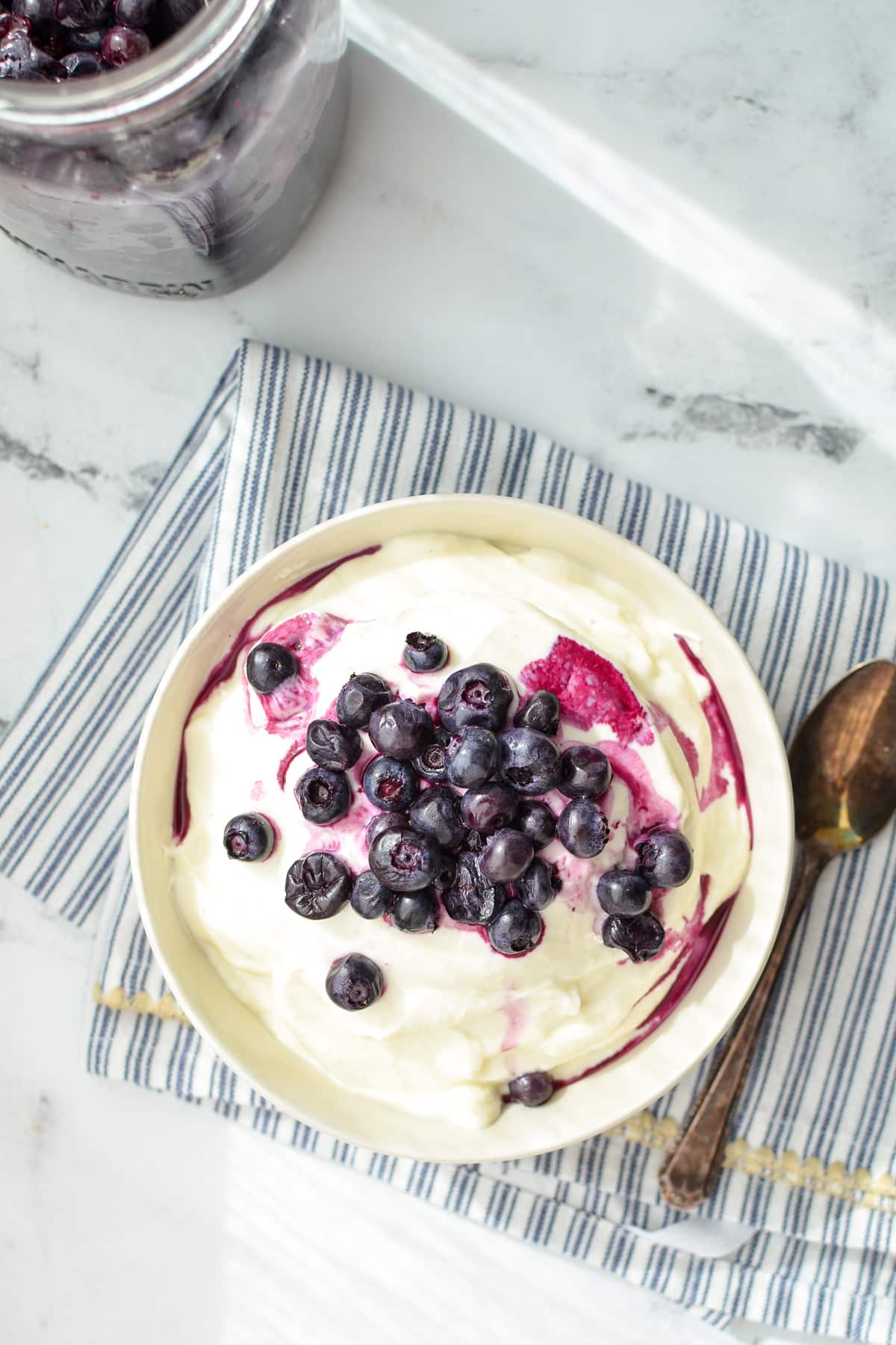 A bowl of yogurt topped with fruit.